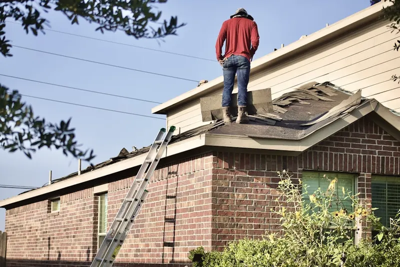 Professional roofer working on a residential roof in Watauga